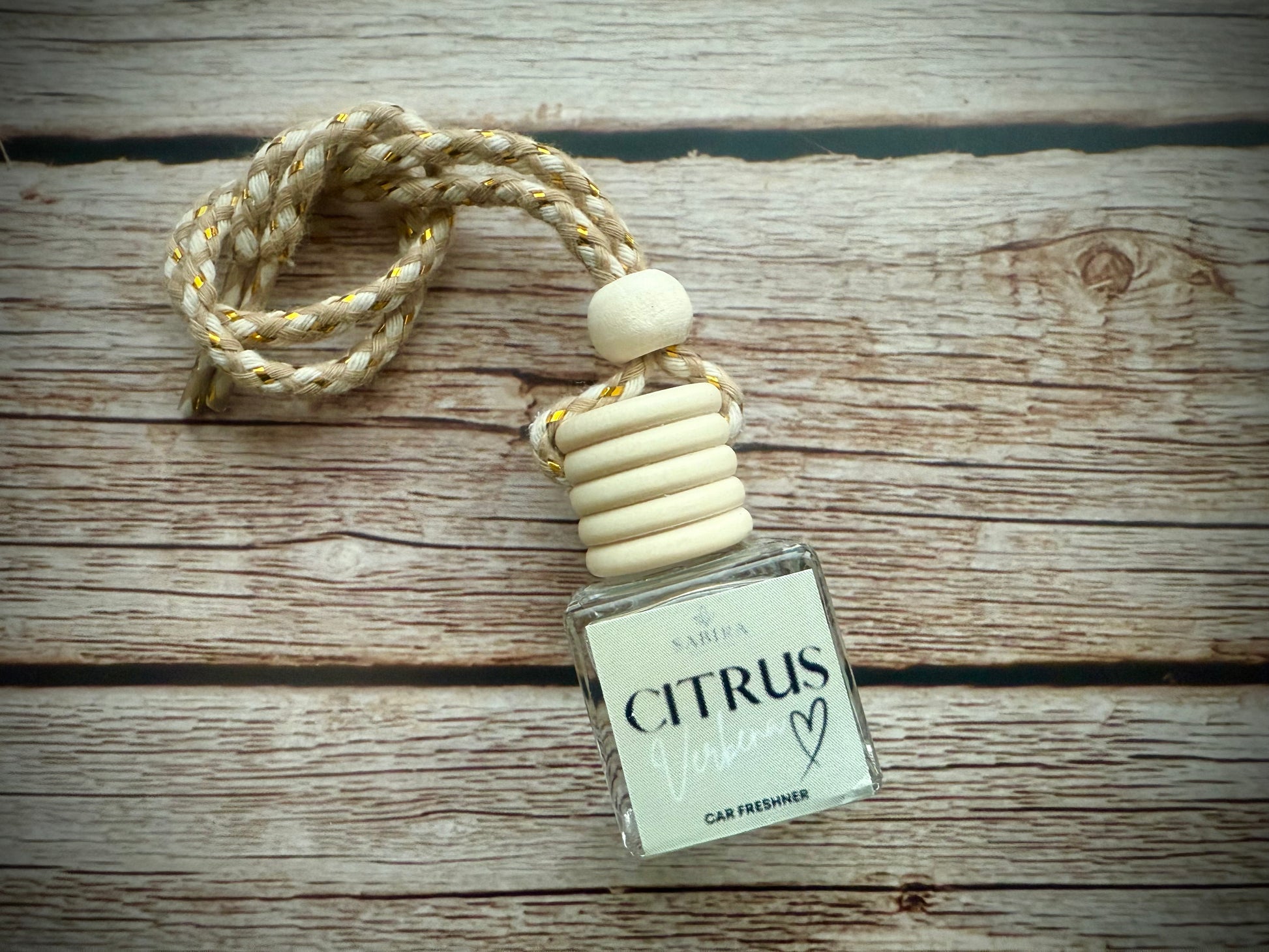 Hanging car freshener with a Citrus Verbena fragrance. 