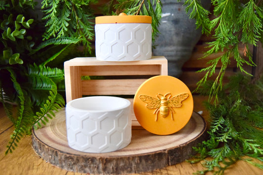 Decorative small storage jars  with white containers with honeycomb design and a gold bee emblem. Handmade  with eco resin.